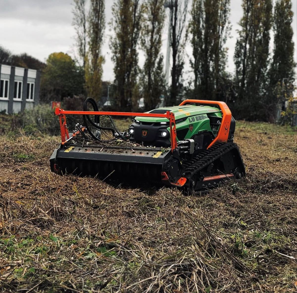Remote-controlled vegetation management machinery clearing commercial land
